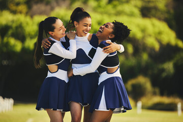 Teamwork, hug or happy cheerleader with women outdoor in training or sports event together. Celebrate, smile or proud friends or excited cheer squad group on field for support, winning or fitness - obrazy, fototapety, plakaty