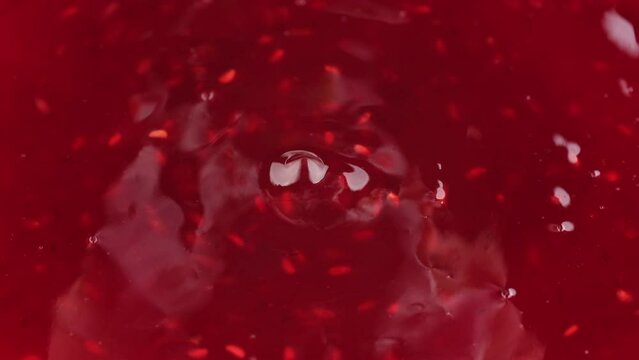 Pouring raspberry jam, close up