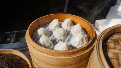 Xiaolongbao steamed pork soup dumplings bun in bamboo basket.
