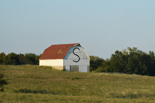 Old White Barn in a Farm Field