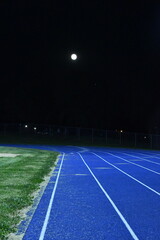 Fototapeta na wymiar Full Moon Over a Running Track