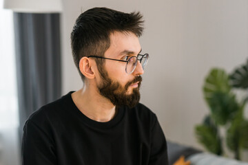 Sad man pondering about his life after a relationship breakup or bipolar disorder copy space -...