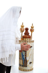 A Jewish man wearing a tallit holds a Torah scroll in his hands on a white background.