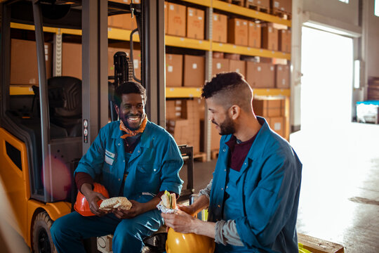 Two young people having lunch on a break from working a warehouse