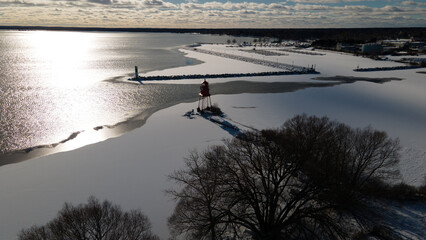 Alpena, Michigan historic lighthouse along Lake Huron in the winter.