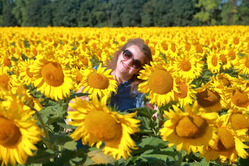 Portrait of a young woman in sunflowers.