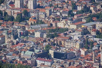 Sarajevo, Bosnia and Herzegovina - Sep 28, 2023: Distant view of Sarajevo city in Bosnia and Herzegovina federation from the surrounding viewpoints in a sunny summer afternoon. Selective focus.