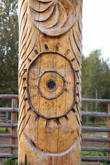 Wooden carved totem pole on the territory of an amusement park. Wooden carved totem pole in the...
