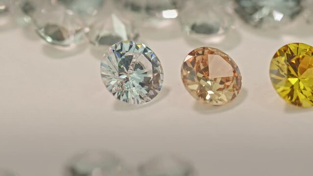 .different types of diamonds are arranged in a row in front of a pile of white diamonds..The diamonds are of the highest quality and cut, .making them a perfect choice for any special occasion.