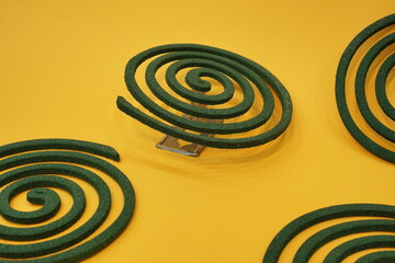 Mosquito coils on isolated orange background