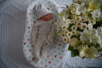 Newborn baby surrounded by beautiful flowers