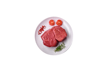 Raw fillet steak mignon beef with salt, spices and herbs