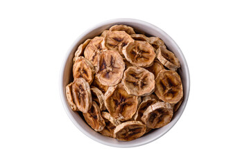 Round slices of sweet banana on a dark concrete background