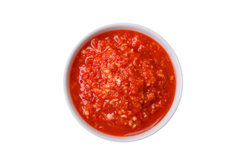Delicious hot spicy red sauce with salt and spices in a ceramic bowl