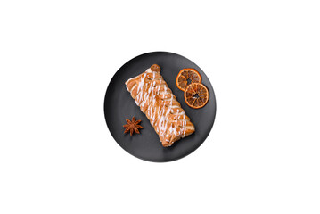 Delicious crispy braided bun with raisins inside and white icing outside