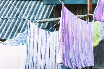 Clean washed laundry hanging on the rope outdoors.
