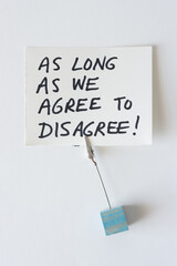 handwritten black felt-tip marker note: as long as we agree to disagree!