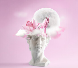 David head with lotus, unicorn and full moon on its head on pastel pink background. Romantic art...