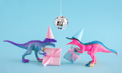 Cute blue and pink dinosaurs wearing party hat and holding present box on blue background.
