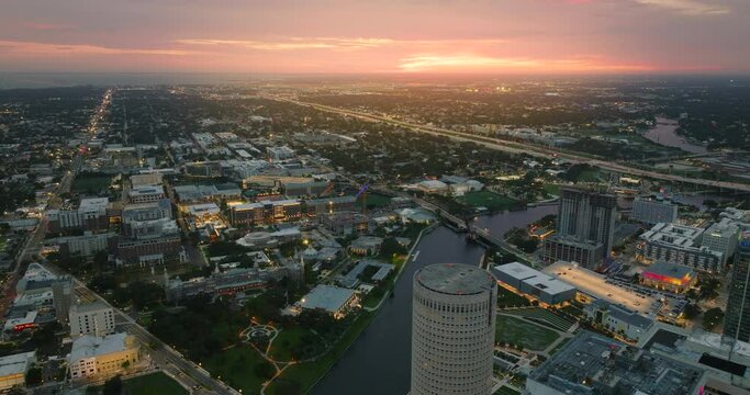 Aerial view of downtown district of Tampa city in Florida, USA at sunset. Brightly illuminated high skyscraper buildings in modern american midtown