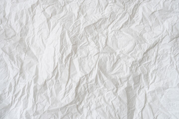 Wrinkled or crumpled white stencil paper or tissue after use in toilet or restroom with large copy space used for background texture in decorative art work