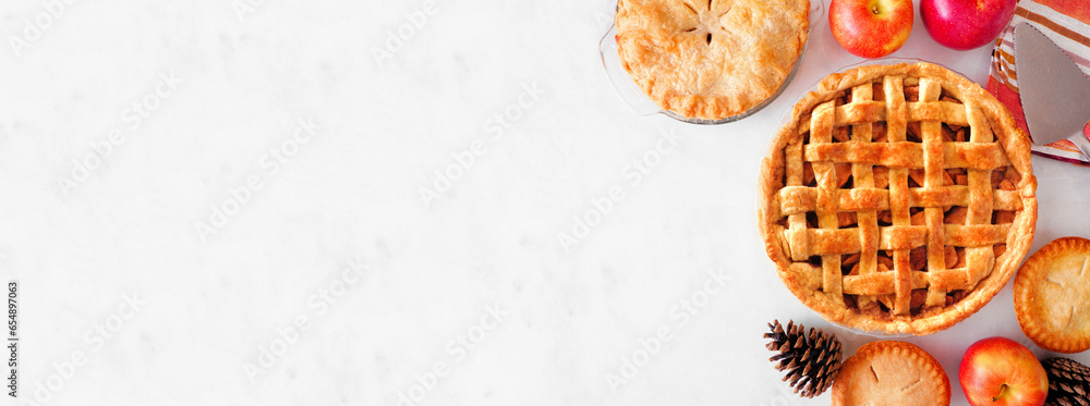 Poster assortment of homemade autumn apple pies. top view table scene side border over a white marble banne