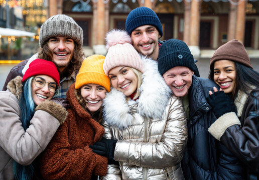 Happy multi ethnic friends having fun outdoor - Trendy tourist smiling on camera during winter vacation - Travel, friendship and holidays concept - Focus on middle woman