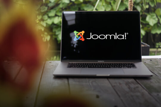 Joomla logo, a free and open-source content management system (CMS), displayed on a MacBook Pro screen