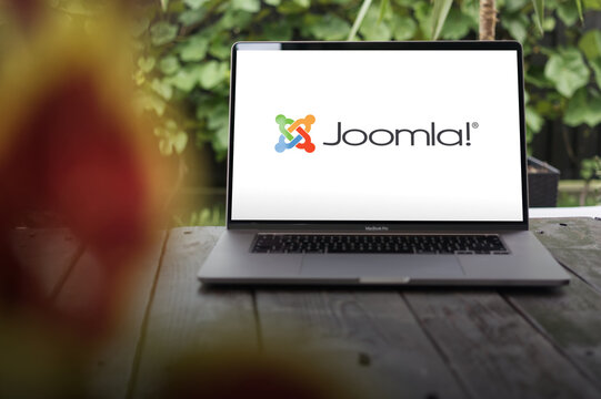 Joomla logo, a free and open-source content management system (CMS), displayed on a MacBook Pro screen