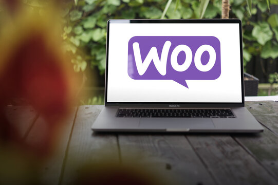 WooCommerce logo, an open-source e-commerce plugin for WordPress, displayed on a MacBook Pro screen