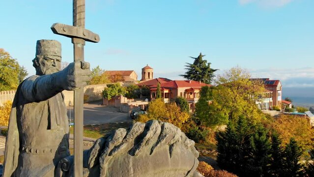 Telavi, Georgia - 6th November, 2022: Aerial close up Monument of king Erekle II . Beautiful view of Kakheti landscape from Telavi. Alazani valley and red roof houses in Kakheti