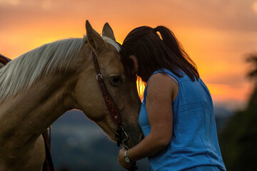Horse and equestrian team: A young woman and her palomino caballo deporte espanol horse during...