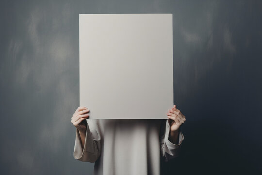 Young woman standing with blank cardboard with copy space. Protest Concept.