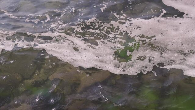 Slow motion closeup shot of clear water waves of a lake