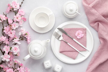 Breakfast concept, morning tea party. Spring flowers. White ceramic tableware and cutlery. Table...