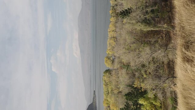 Slow motion pan of Sevan lake in October on a hazy day