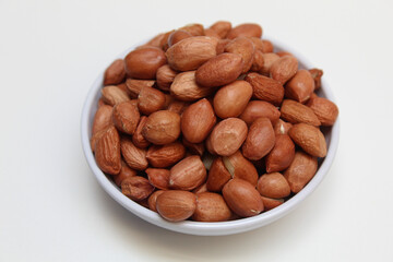 Peanuts or groundnut, or goober, or monkey nut. Peeled peanuts with thin red skin. Isolated on white background