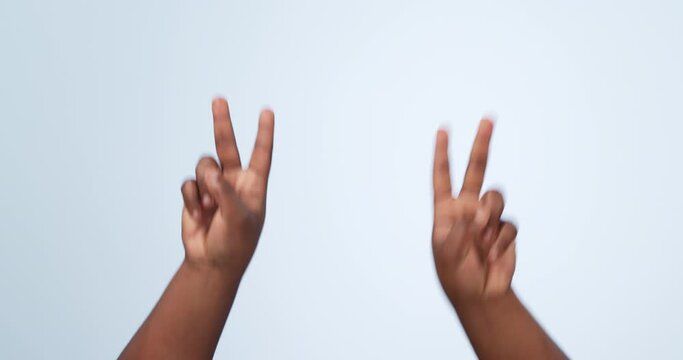 Hands and peace sign in studio with freedom, counting or emoji gesture with number. Count, finger and arms of a person with greeting, vote and v letter with blue background and happy icon