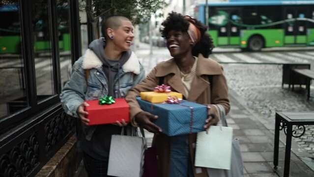 Young interracial lesbian couple buying presents for each other in the city