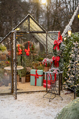 Beautifully decorated backyard with gift boxes, christmas tree and wreaths on winter holidays at...