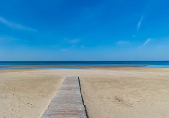 Crédence de cuisine en verre imprimé Descente vers la plage Wooden deck along the sandy beach leading to the deserted shore of the Baltic Sea in Jurmala, Latvia. The concept of natural minimalism.