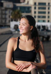 Fototapeta na wymiar Young Asian Female Smiling Outdoors