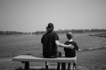 Son and Dad sitting on a bench
