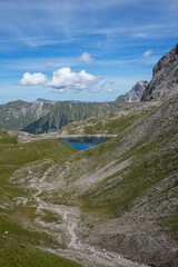 Fototapeta na wymiar Clear blue lake of summits in the mountains