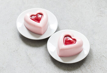 Raspberry cream pudding, Panna Cotta in the shape of a heart with raspberry sauce in the center. On...