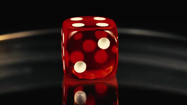 Red D6 dice rotating board game macro with reflections 4K