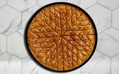 tray homemade traditional algeria almond and honey baklava with almond for ramadan on hexagon tiles background