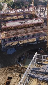 Vertical Video of Construction Workers in the Roof of New Building 