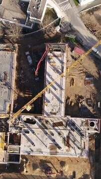 Vertical Video of Construction Workers in the Roof of New Building 