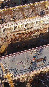 Vertical Video of Construction Workers in the Roof of New Building 